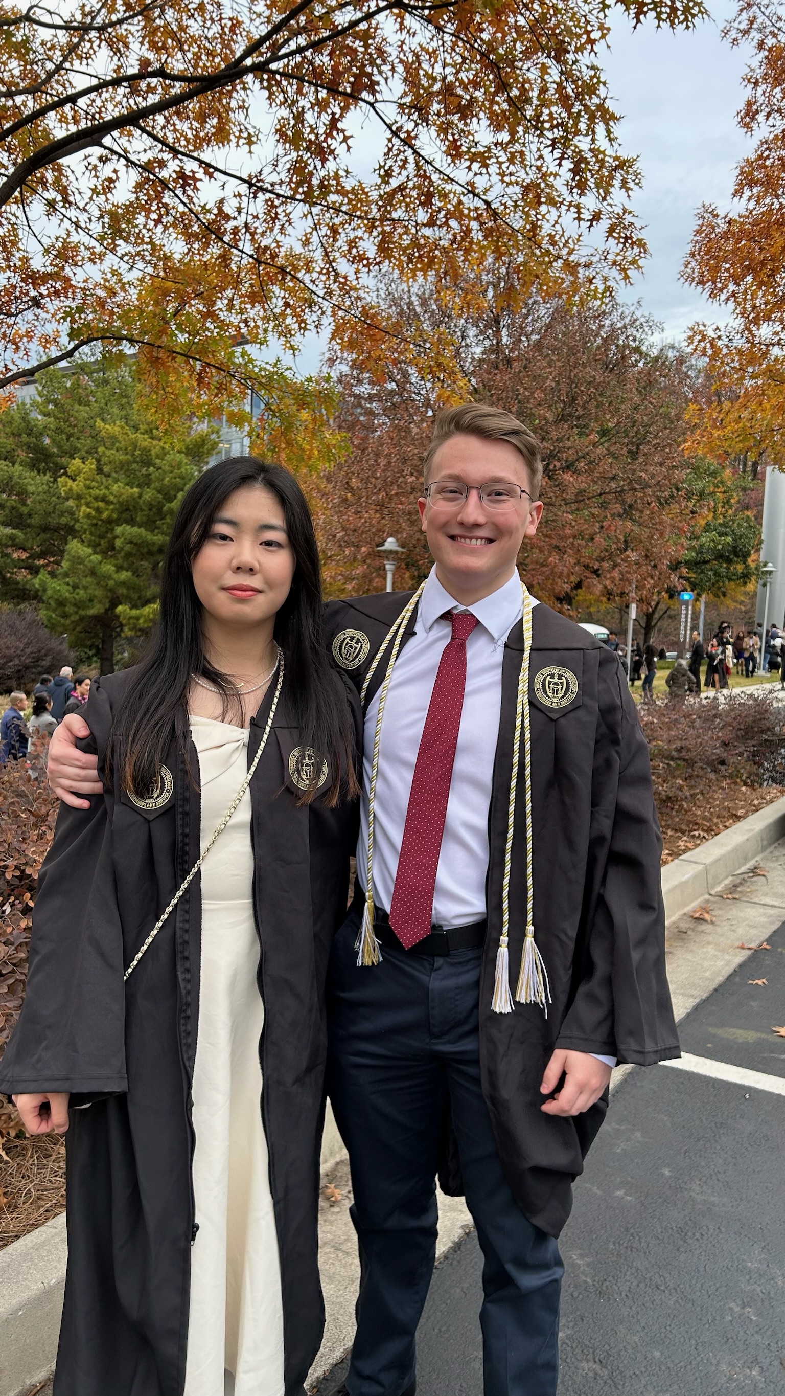 Angela and Aidan together in graduation robes